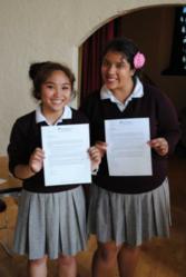 Krizette Garcia and Angelina Mesta hold up acceptance letters to NDNU received at On-Site Admissions Day